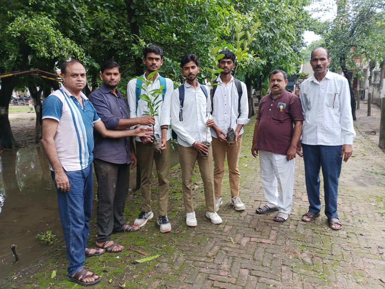 Students carrying saplings to be planted